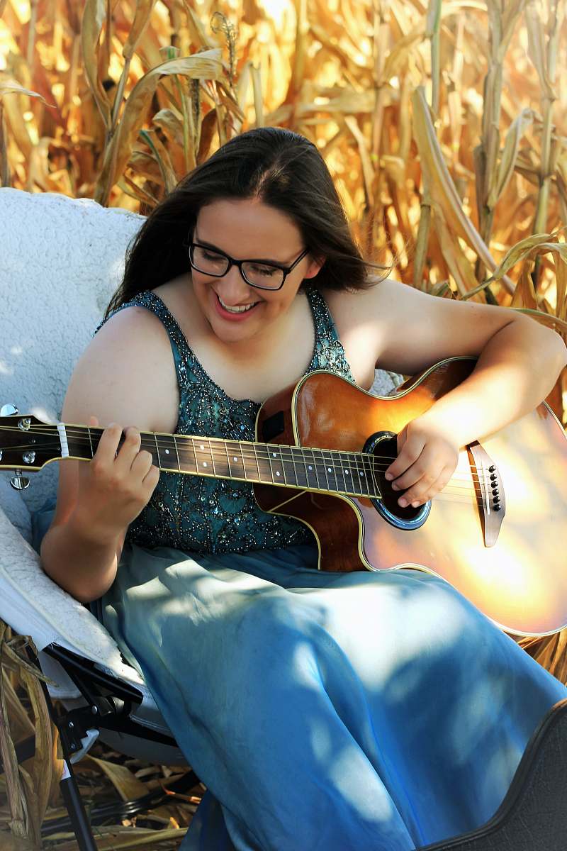 leisure activities woman playing guitar musical instrument